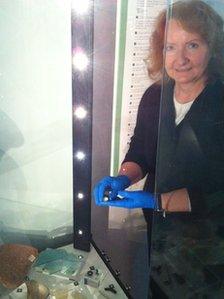 Gill Levy adds a Roman ring to a display case at the Winding House museum