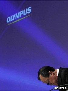 Olympus chairman Shuichi Takayama bows in apology