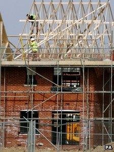 Builders at work on a house