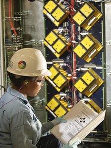 Woman oil worker looking at plans