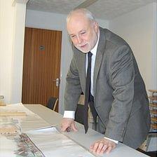 Derek Neale looking at plans for Les Beaucamps High School