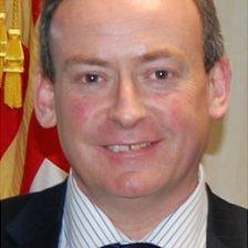 Lyndon Trott in front of a Guernsey flag