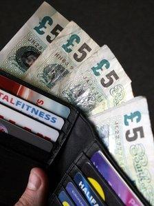 £5 notes in a wallet