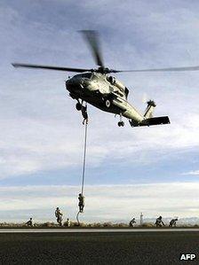 Seals practice fast roping from a SH-60B Seahawk helicopter