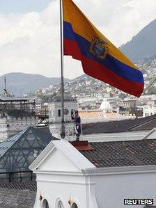 Ecuadorean presidential guards rise the national flag during a special change of presidential guards ceremony marking President Rafael Correa's fifth year as president on 16 January