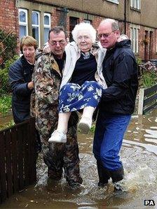 Morpeth residents leaving flooded homes in 2008. Photo: PA