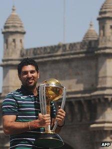 Cricketer Yuvraj Singh poses with the World Cup trophy in Mumbai in April 2011