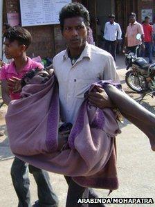 A victim of the toxic alcohol in Orissa being taken to hospital on 8 February 2011