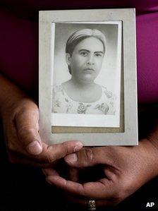 Felicita Romero holds an image of her mother Natividad Ramirez, a victim of the Dos Erres massacre