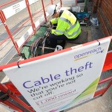 BT worker handling cables