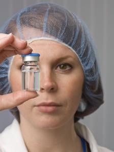 Worker examines vial