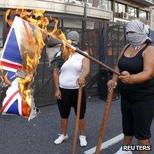 Activists in Argentina burn the Union Jack flag