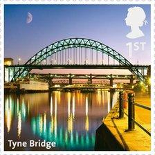 Tyne Bridge at night with Tuxedo Princess moored beneath, on a Royal Mail stamp