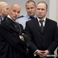 Anders Behring Breivik (R) with his lawyer Geir Lippestad (L) and guards in court (18 April)