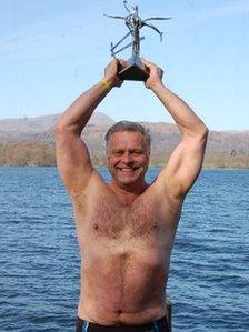 Thomas Noblett holding a swimmer of the year award