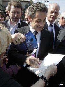Nicolas Sarkozy signing a book