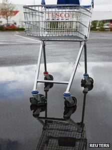 Tesco trolley in a puddle