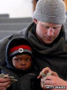 Prince Harry with a child in Lesotho