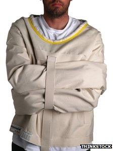 A stock photo of a man in a straight jacket