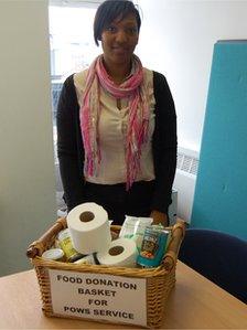 Lynette Oyaide in front of a food donation basket