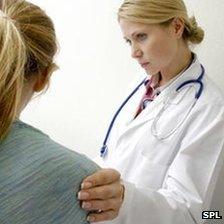 Doctor consoling a young woman