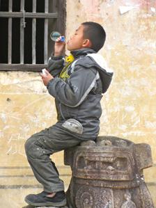 Kid blows bubbles