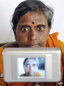 A woman being photographed at an identity centre in India