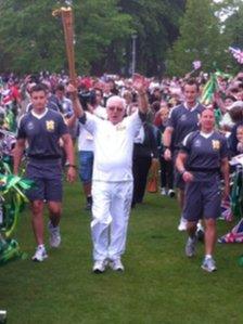 Ronald Price carrying the flame in Wrexham