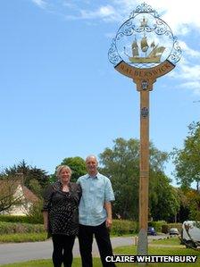 Lea and Philip Newstead next to the restored Walberswick sign