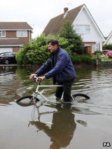 Man with bike in flood