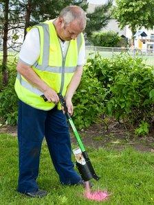 Council worker spray painting poo