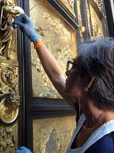 A restorer works on the Gates