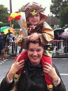 Archie Garrigan on his mother Katy's shoulders