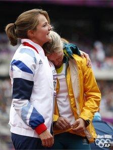 Britain's Goldie Sayers, left, and Australia's Kimberley Mickle embrace during a women's javelin throw qualification round at the London Olympic Stadium, 7 August