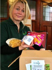 A North Lakes Foodbank volunteer packs a box