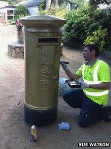 Sark's post box being painted gold