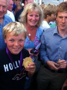 George Matcham, 12, wearing Ben Ainslie's medal