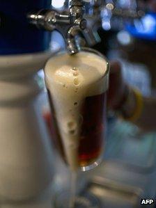 A barman serves Mexican craft beer in a bar in Mexico City, on July 20, 2012.