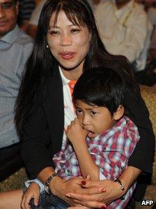 Indian boxer MC Mary Kom with one of her twin boys in her lap