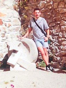 Rob standing next to a Hammer and Sickle in 1992