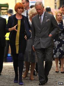 The Prince of Wales talks with Mary Portas during a visit to Surrey Street Market in Croydon, London