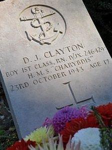 Flowers laid at the gravestone of a crew member of HMS Charybdis