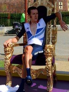 Bradley Wiggins sitting in a victory throne at Hampton Court