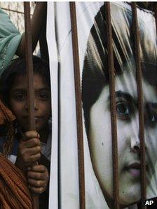 A Pakistani girl with a banner of Malala Yousafzai at a demonstration in Karachi