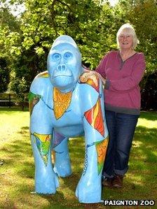 Devon artist Sue Misselbrook with "Herbert" gorilla, featuring flags with African designs