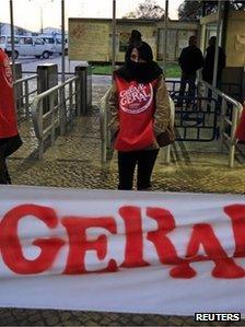 A worker stands at a picket line at Mitrena shipyard, south of Lisbon