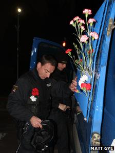 Carnations bedeck a police van in Maribor