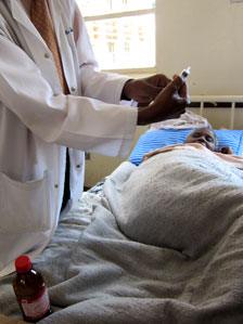 A patient in Uganda being administered morphine