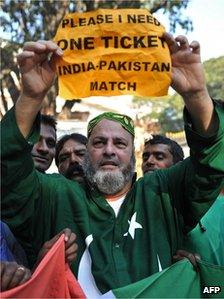 Mohammed Bashir, a 60-year old US-based Pakistani cricket fan, holds up a placard seeking a spare ticket on the eve of the India-Pakistan cricket series in Bangalore on December 24, 2012.