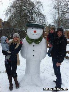 Brian Flannery with Shauna and a snowman built for Jack and William Flannery in Dorridge